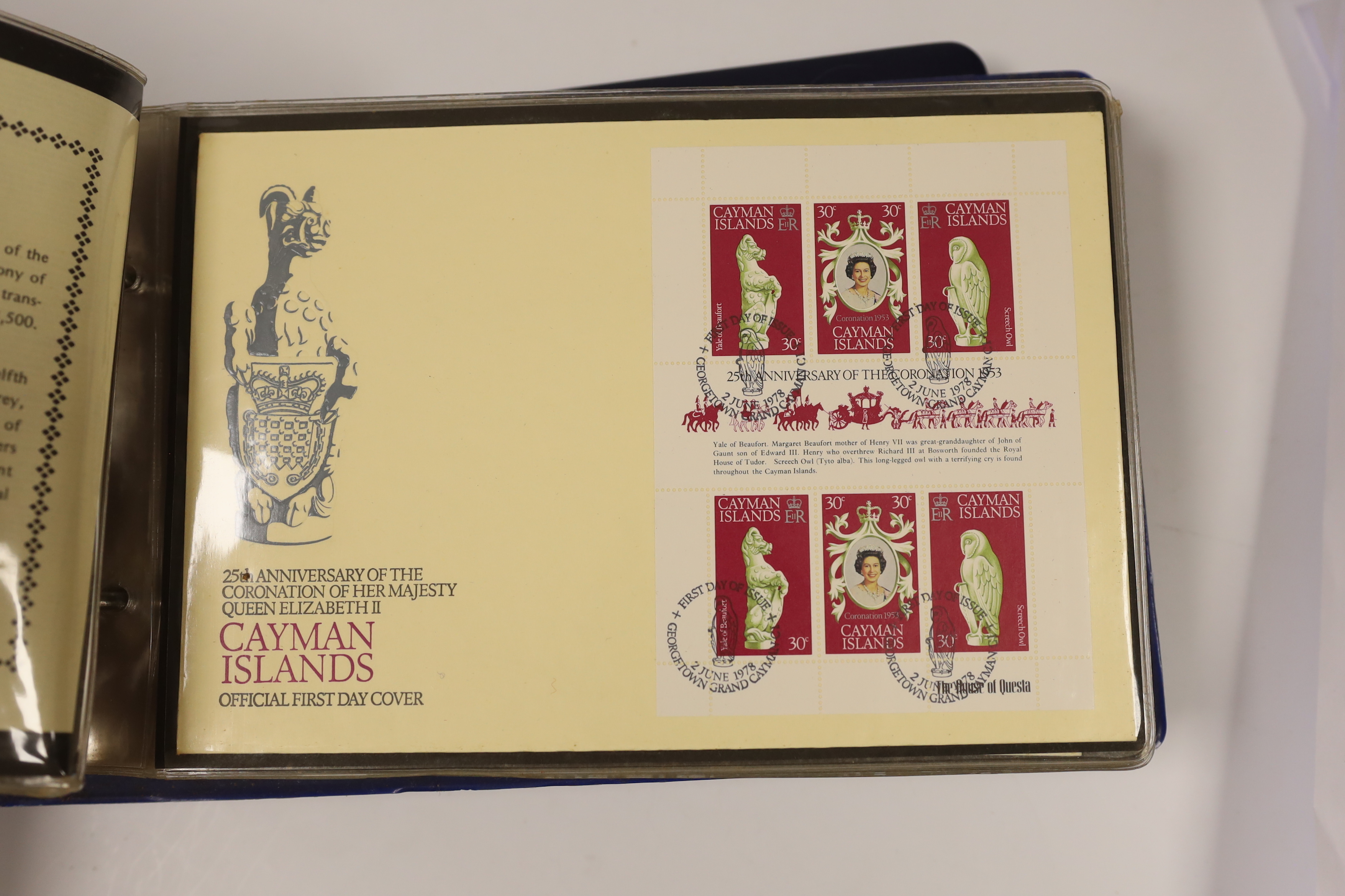 A cased Danbury Mint Queen Elizabeth II Silver Jubilee silver ingot and a Pobjoy Mint 25th anniversary of the Queen's coronation twin silver gilt medallions and First Day covers album